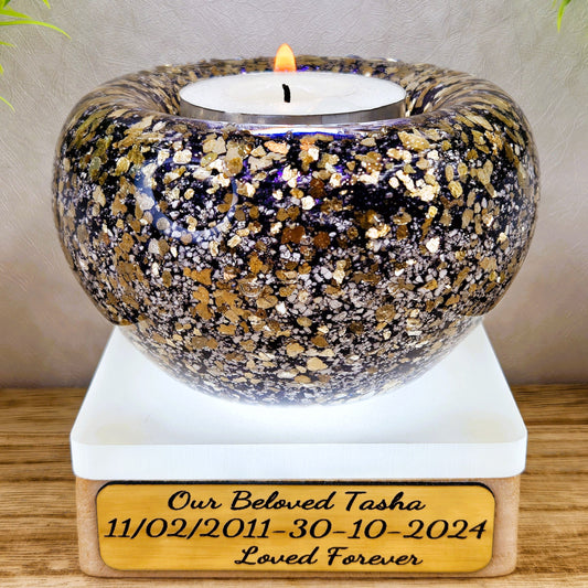 Ashes in glass tealight silver & gold flakes.