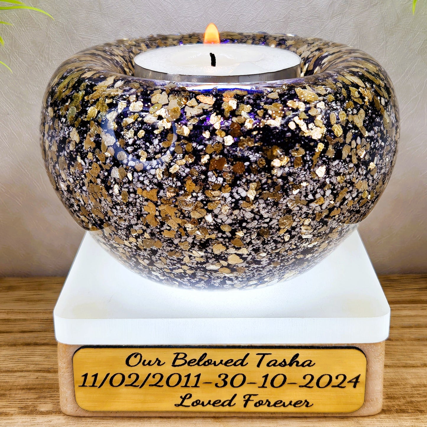 Ashes in glass tealight silver & gold flakes.