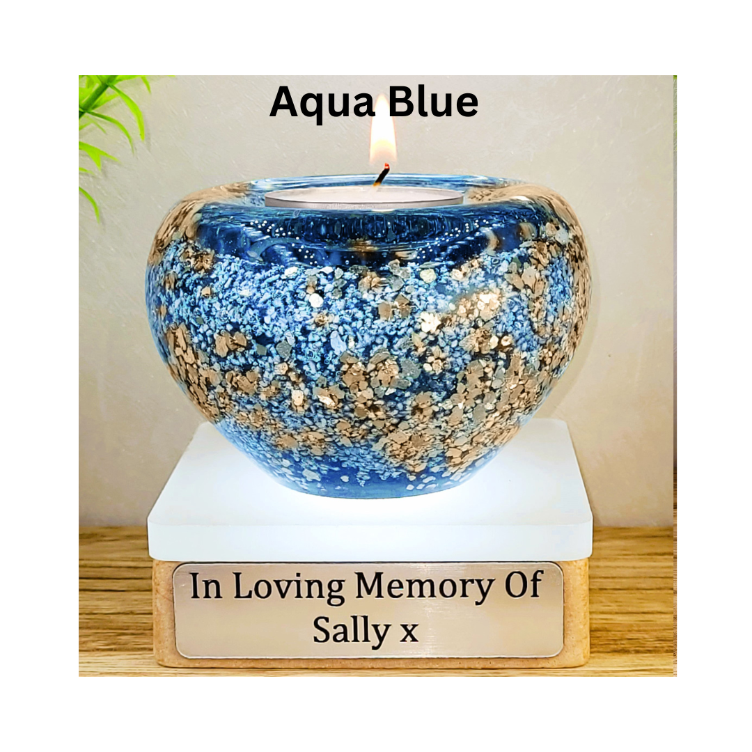 Ashes in glass tealight silver & gold flakes.