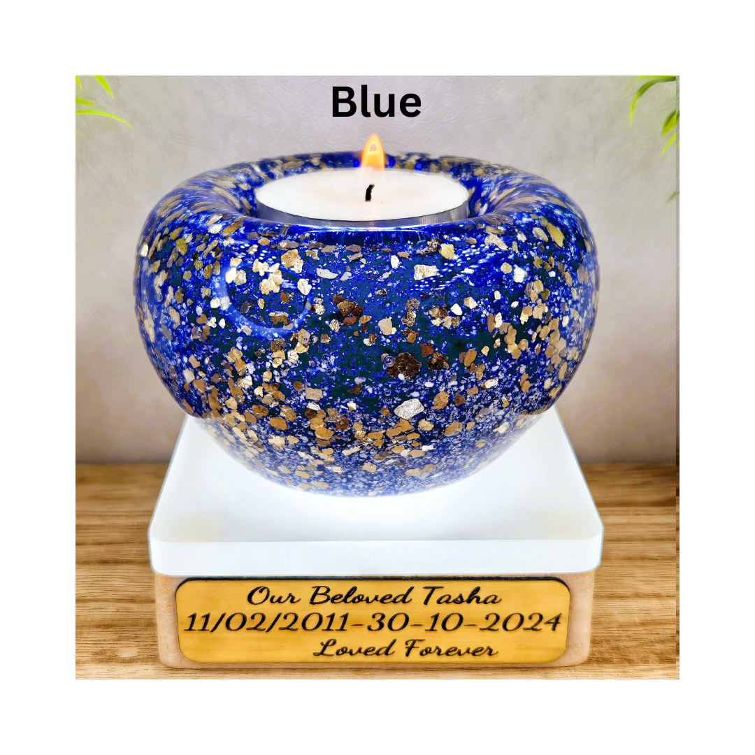 Ashes in glass tealight silver & gold flakes.