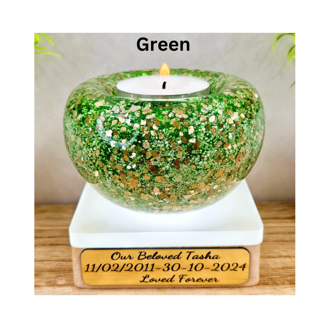 Ashes in glass tealight silver & gold flakes.