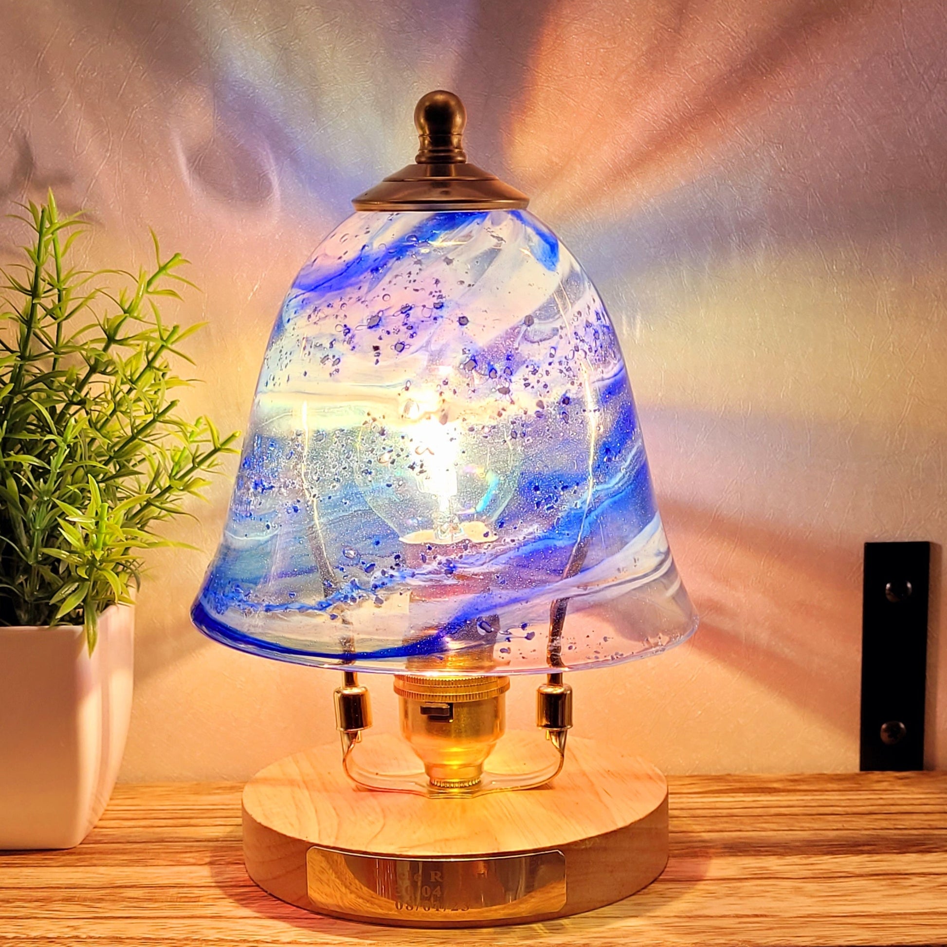 ashes in glass blue lamp