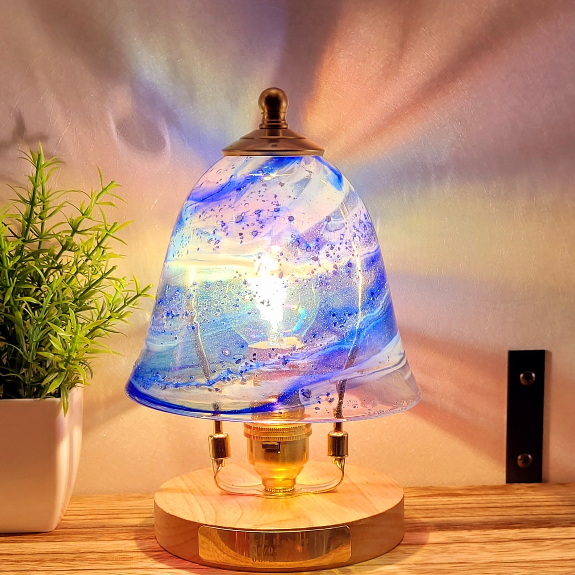 ashes in glass blue swirl lamp