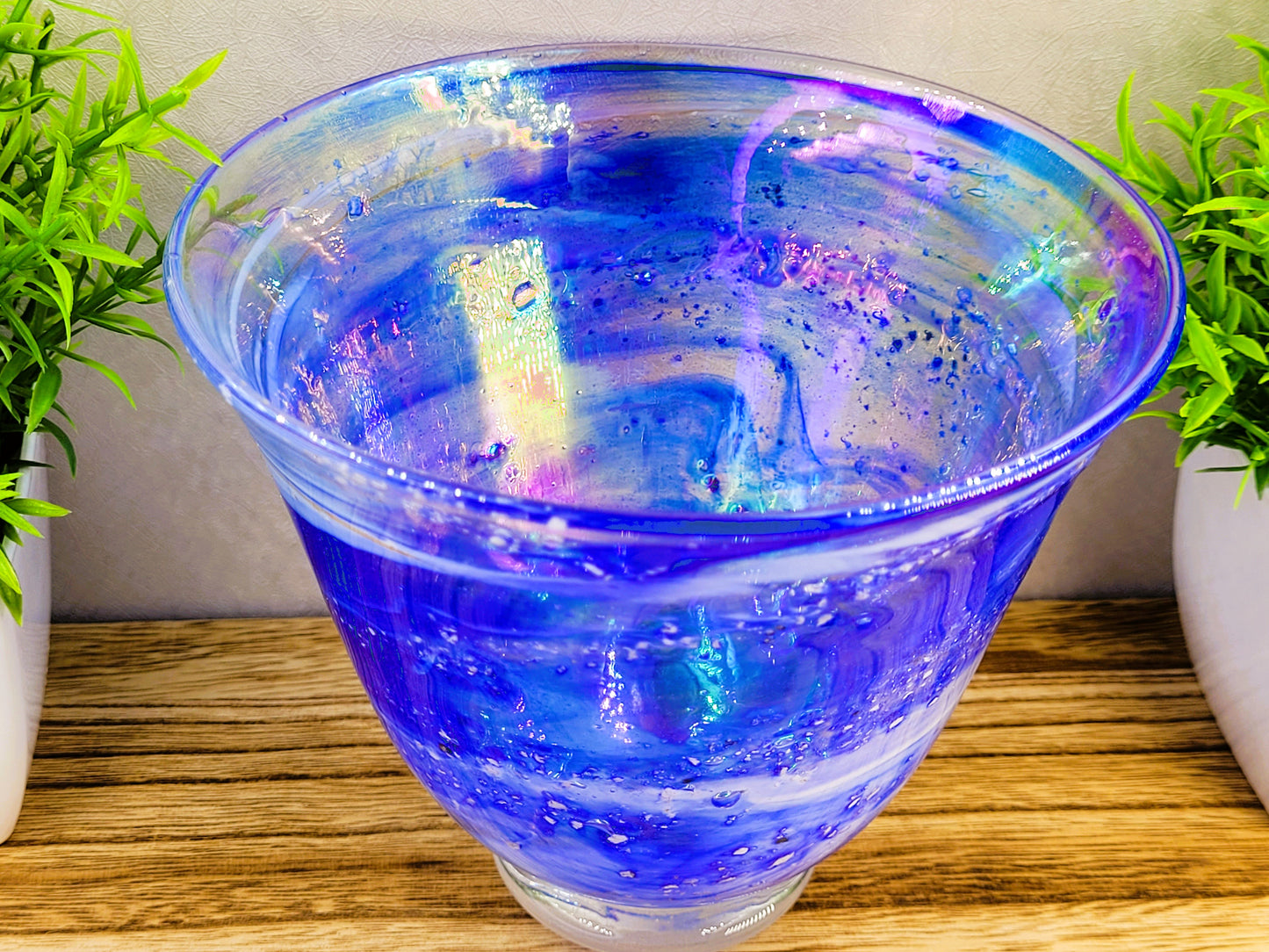 iridescent glaze inside ashes in glass blue vase